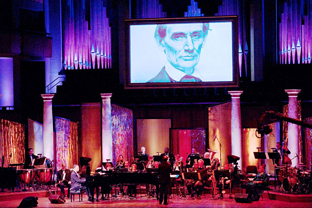 Historic Photo of Abraham Lincoln Illuminates Over the Stage