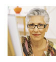 [photo: woman at an easel]