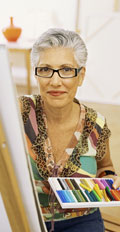 [photo: woman at easel]