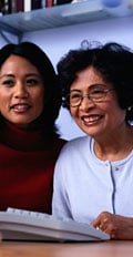 [photo: woman and daughter at computer]