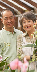 [photo: couple in greenhouse]