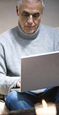 [photo: man with laptop]