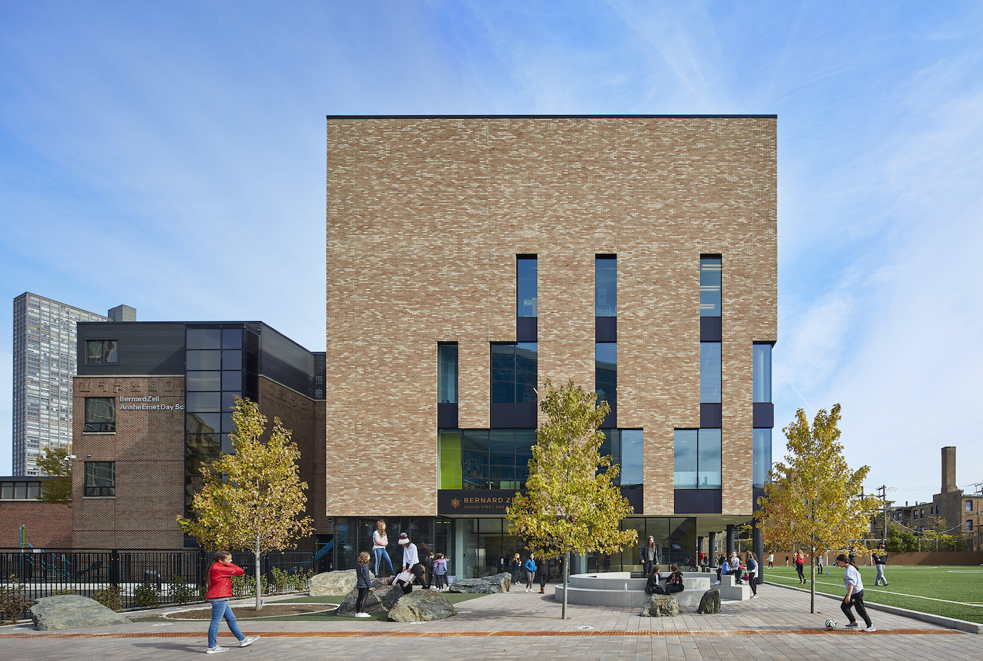 The square box of a building with asymmetrical windows cut out of it