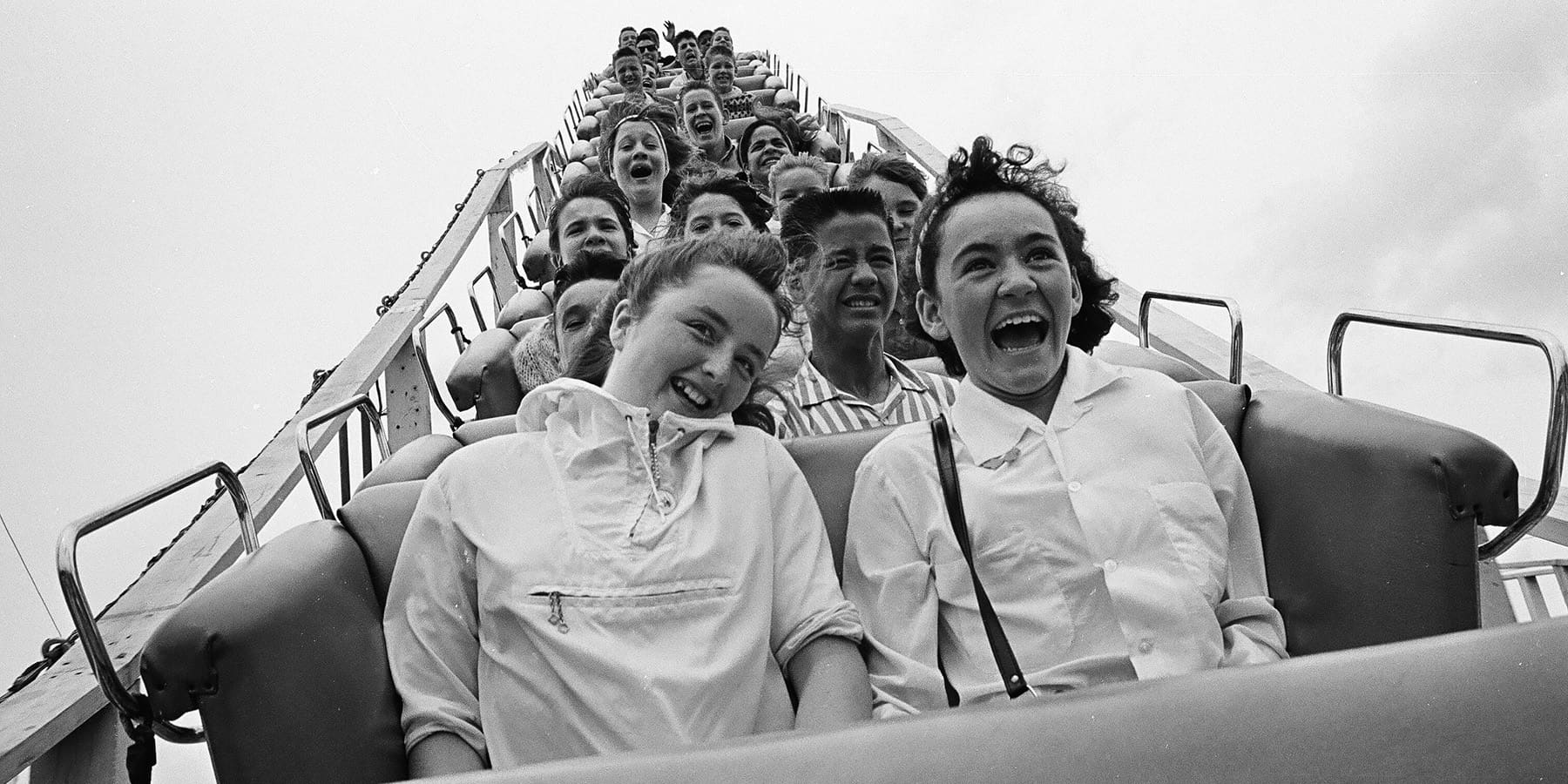 Historical photo showing the passengers on a roller coaster