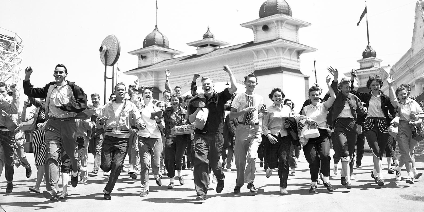 Children run through the entrance of Riverview Park on opening day in 1955