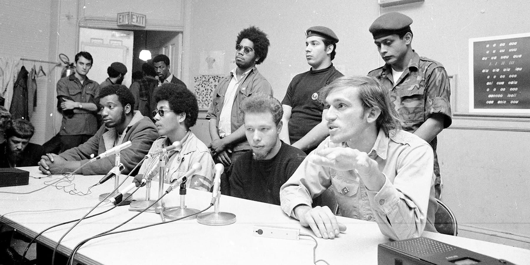 Fred Hamptonand José “Cha Cha” Jiménez sit at a table