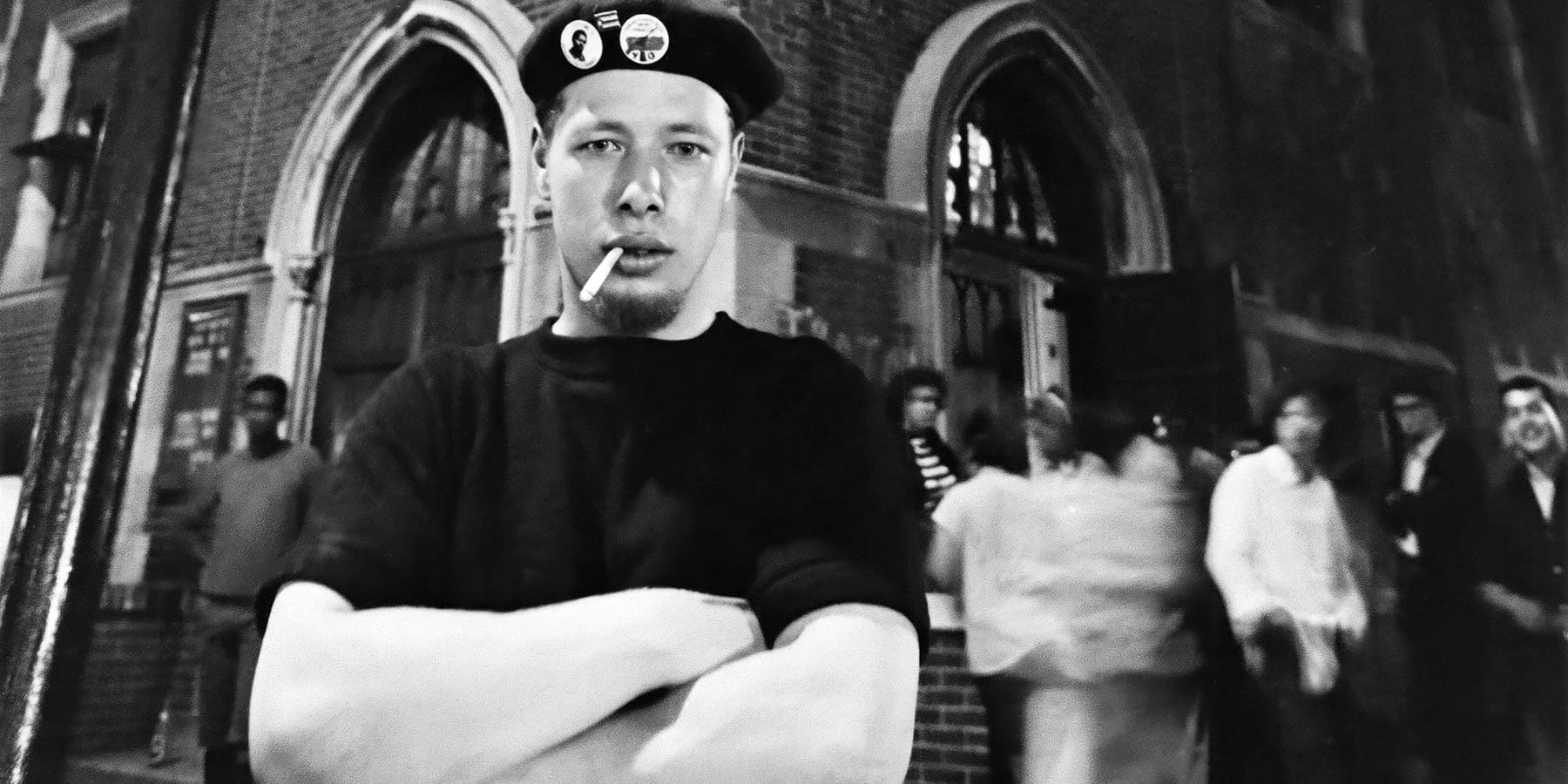 José “Cha Cha” Jiménez stands in a beret with arms crossed