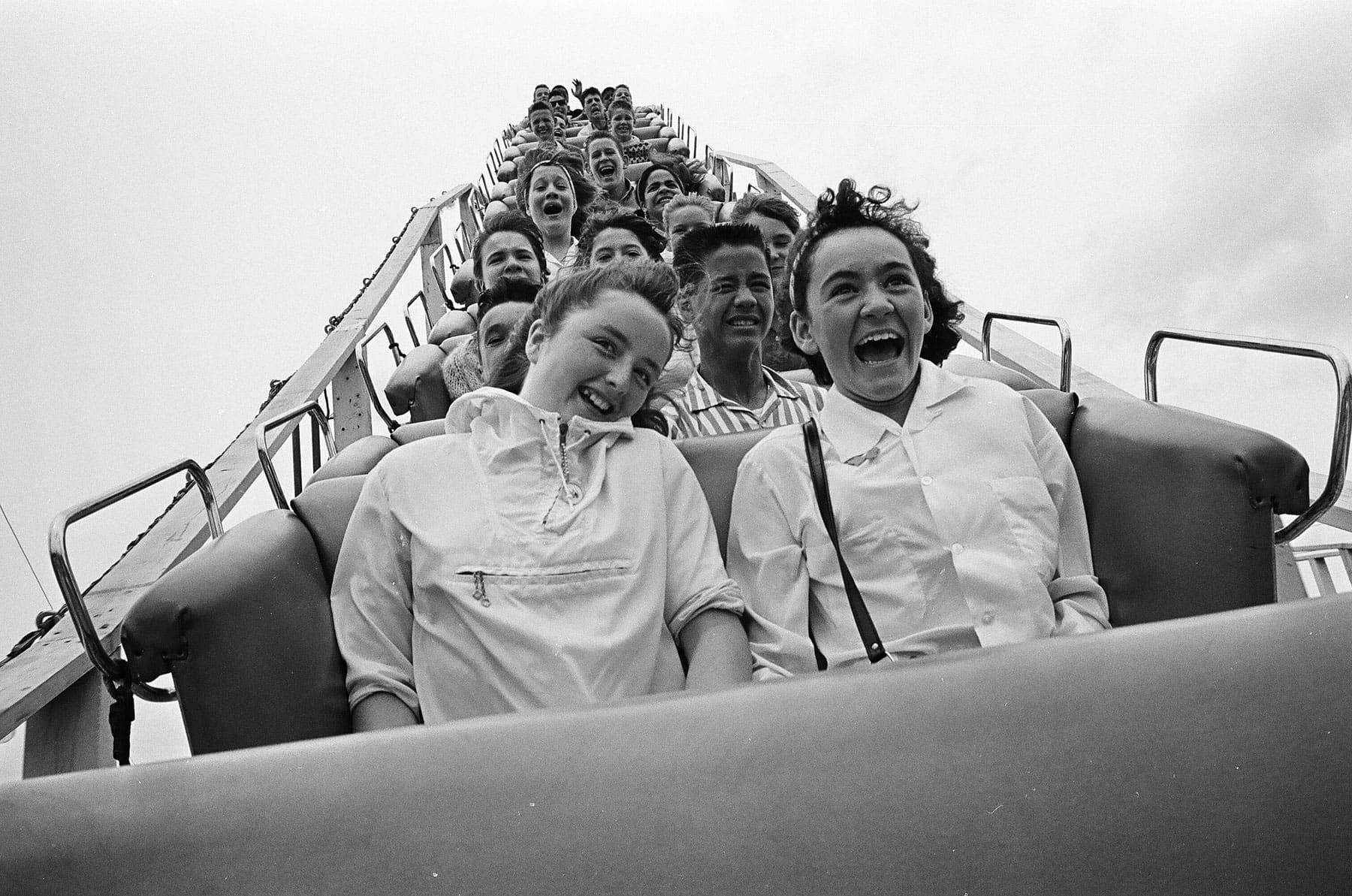 Historical photo showing the passengers on a roller coaster