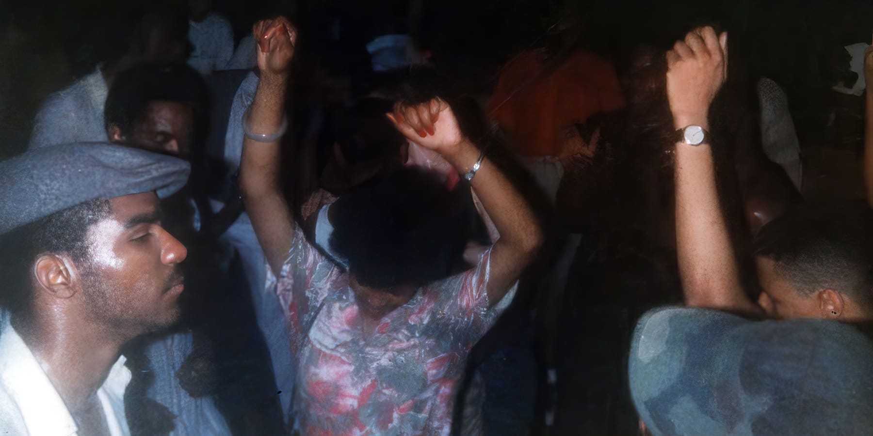 People dancing with arms in the air.