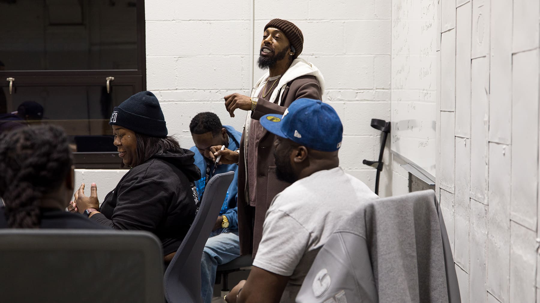 Terrance Henderson stands near a whiteboard presenting to others