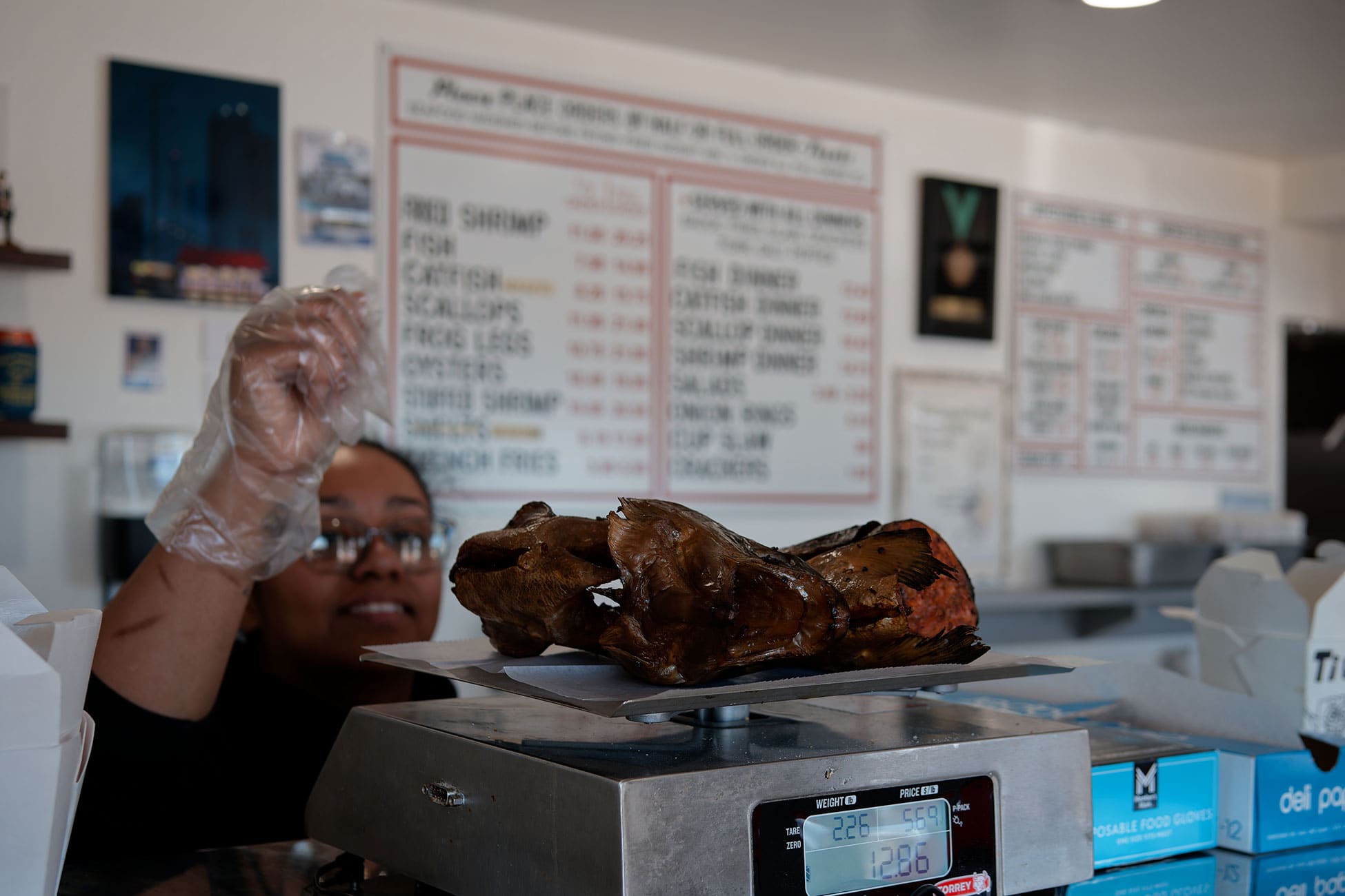 A worker weighs an order for a customer.