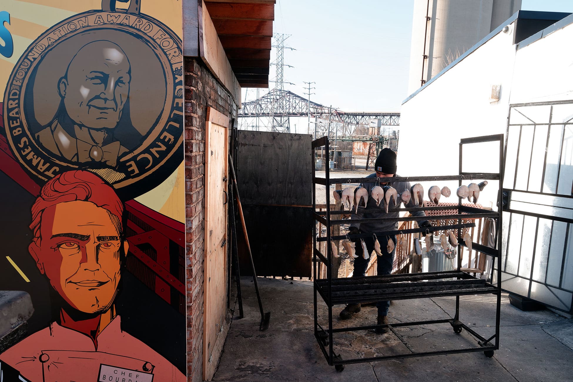 A mural depicts the late chef Anthony Bourdain and the James Beard Award.