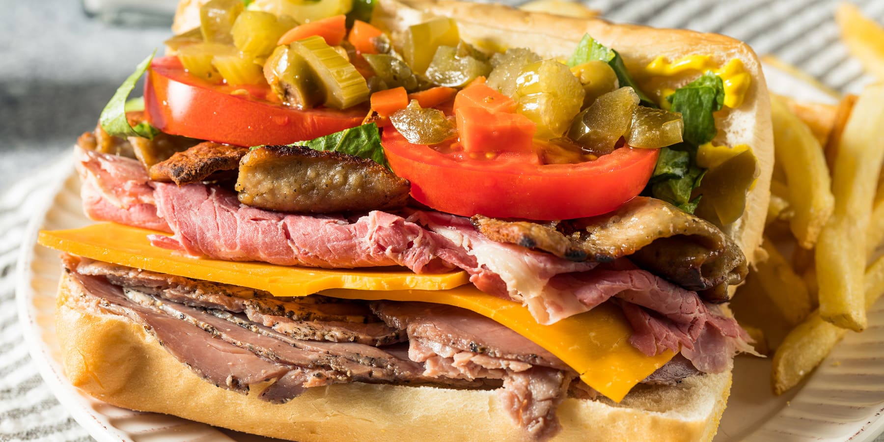A Jim Shoe sandwich is loaded with several kinds of meats and  condiments