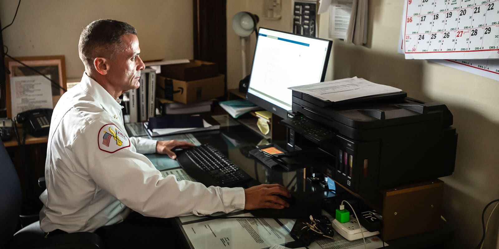 The batalion chief works at a computer