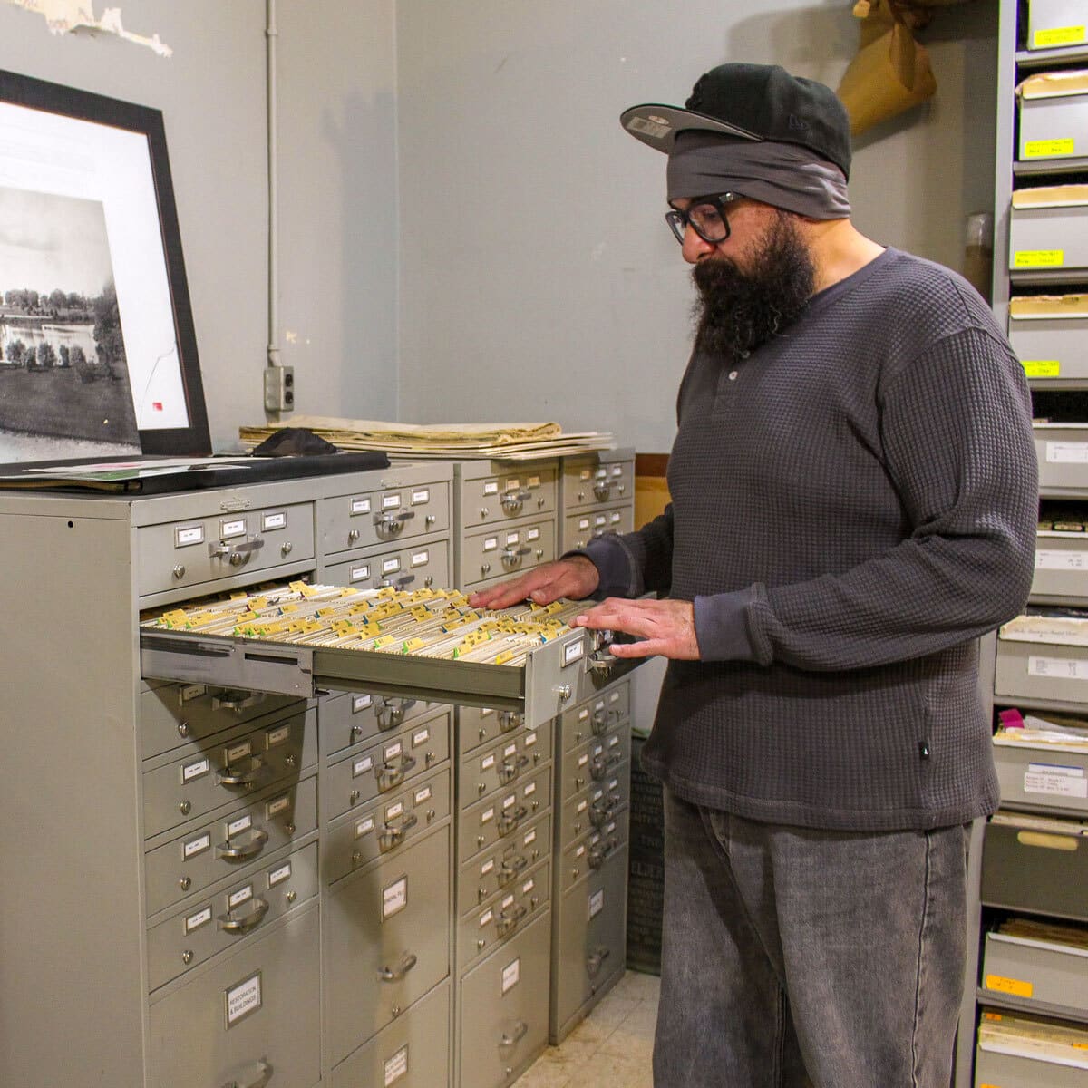 A man looks though file cabinet entries