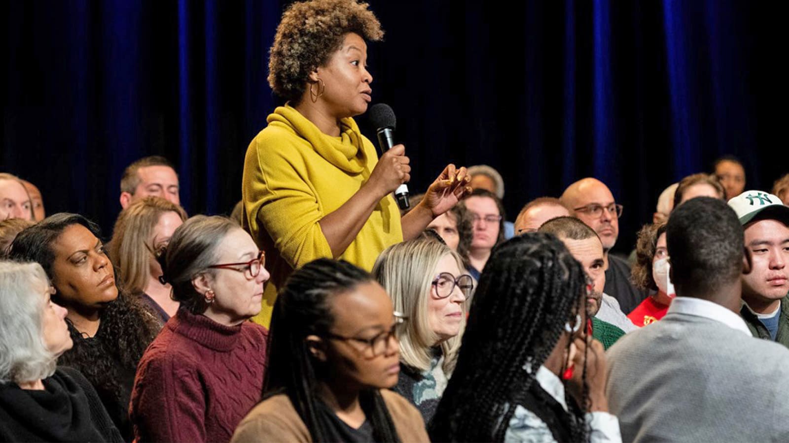 An audience member asks a question during the filming of the Firsthand: Democracy
