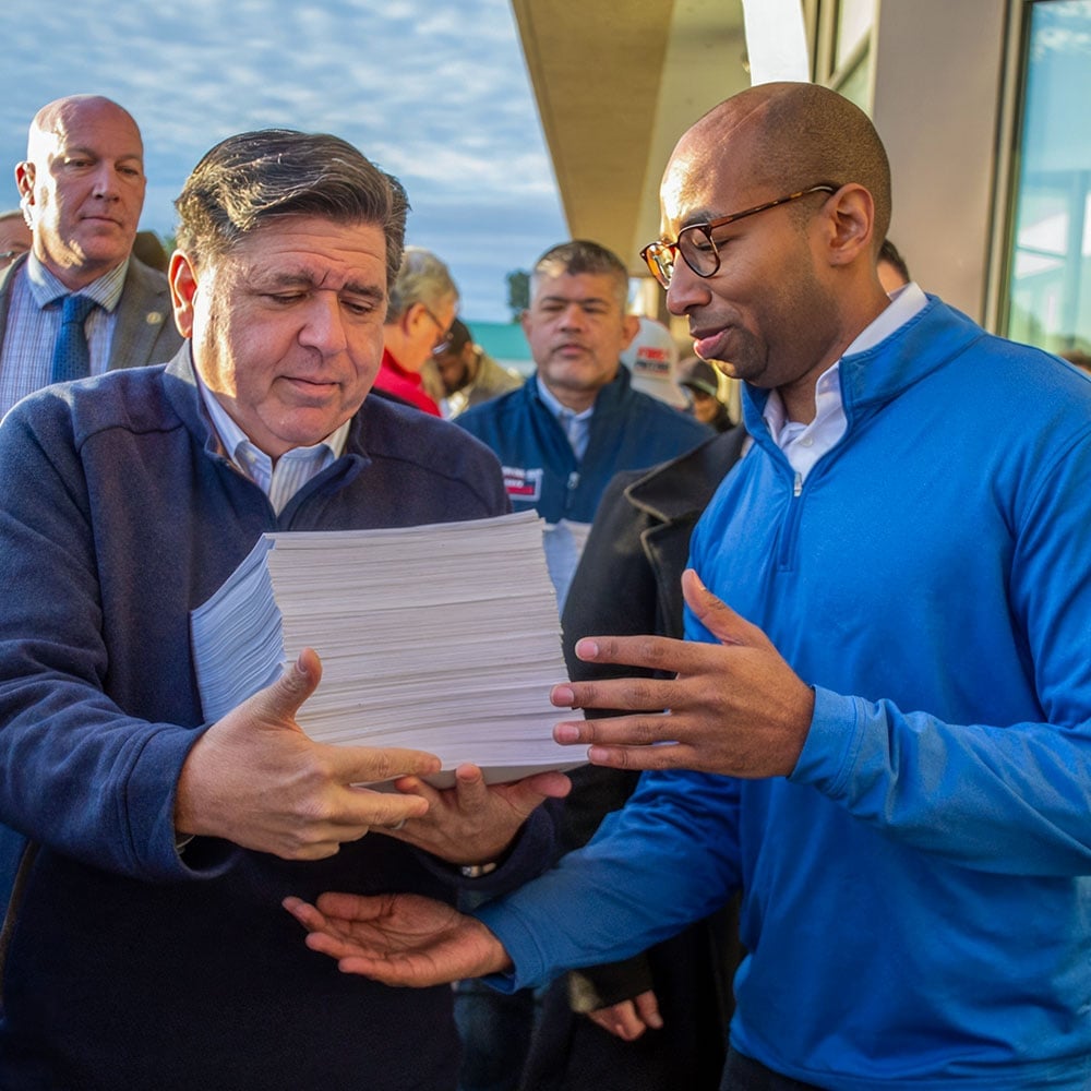 Gov. JB Pritzker and lieutenant governor candidate Christian Mitchell prepare to file nominating petitions at the Illinois State Board of Elections building in Springfield