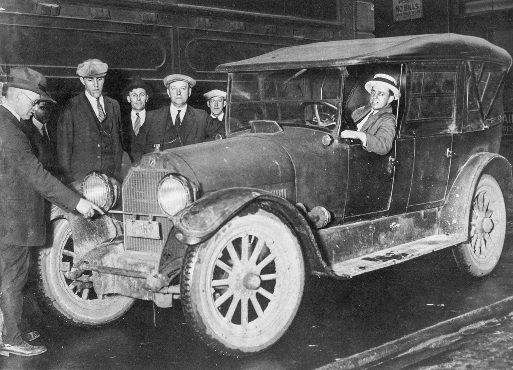 Authorities pose with one of the getaway Cadillacs.