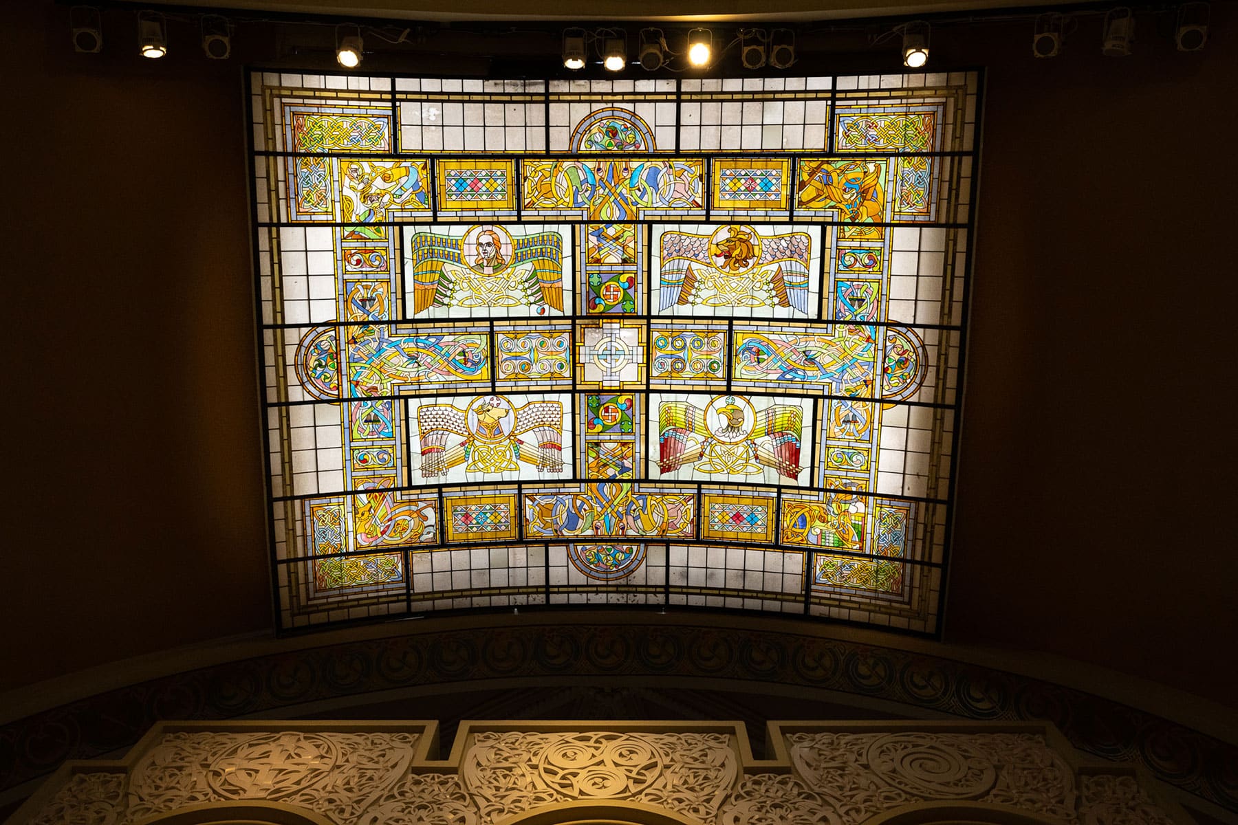 The magnificent stained-glass sanctuary skylight at Old St. Patrick's Church featuring Celtic-inspired designs and the traditional symbols of the Four Evangelists.