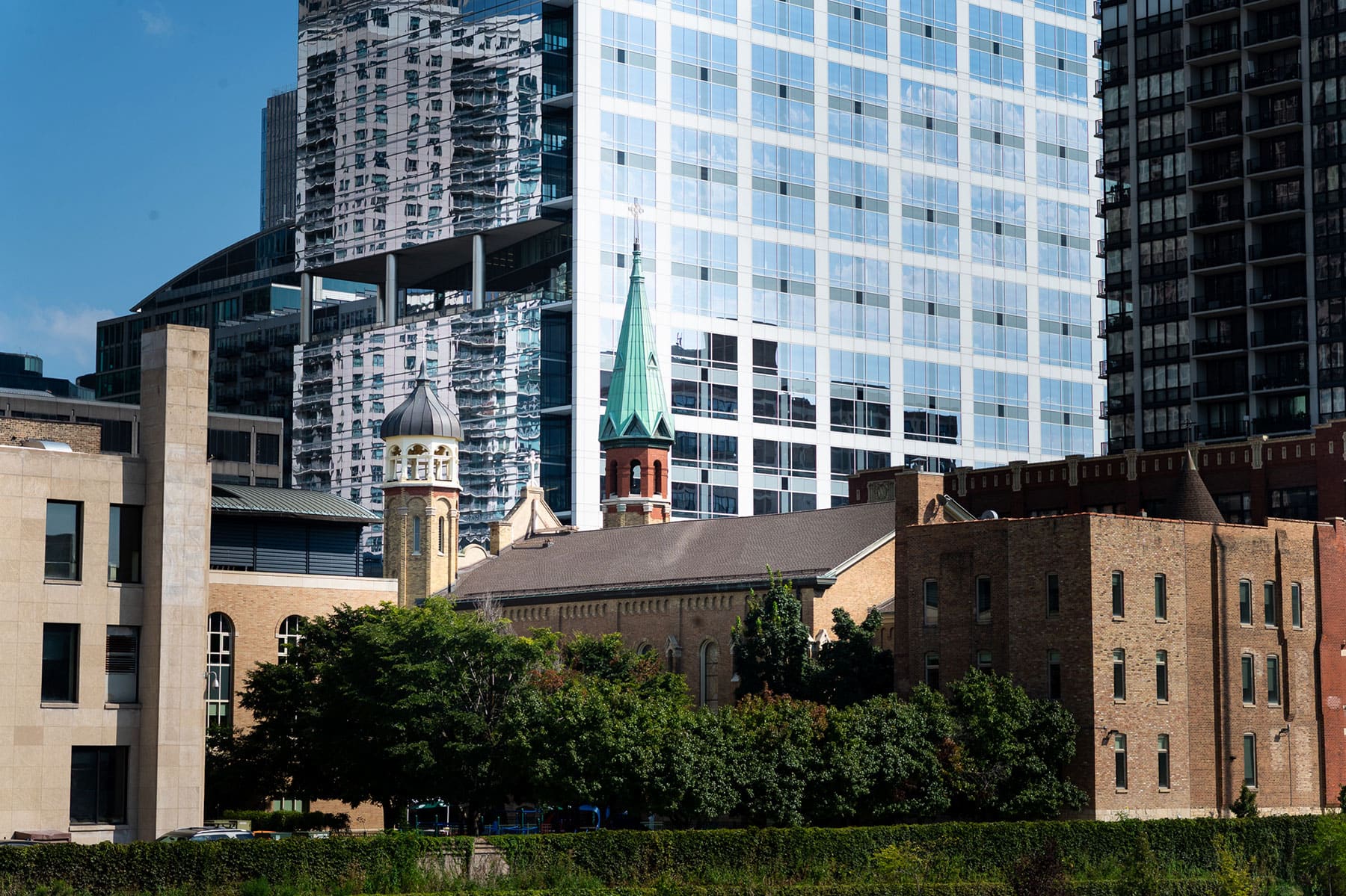 View of Old St. Patrick's Church with taller modern buildings in the background