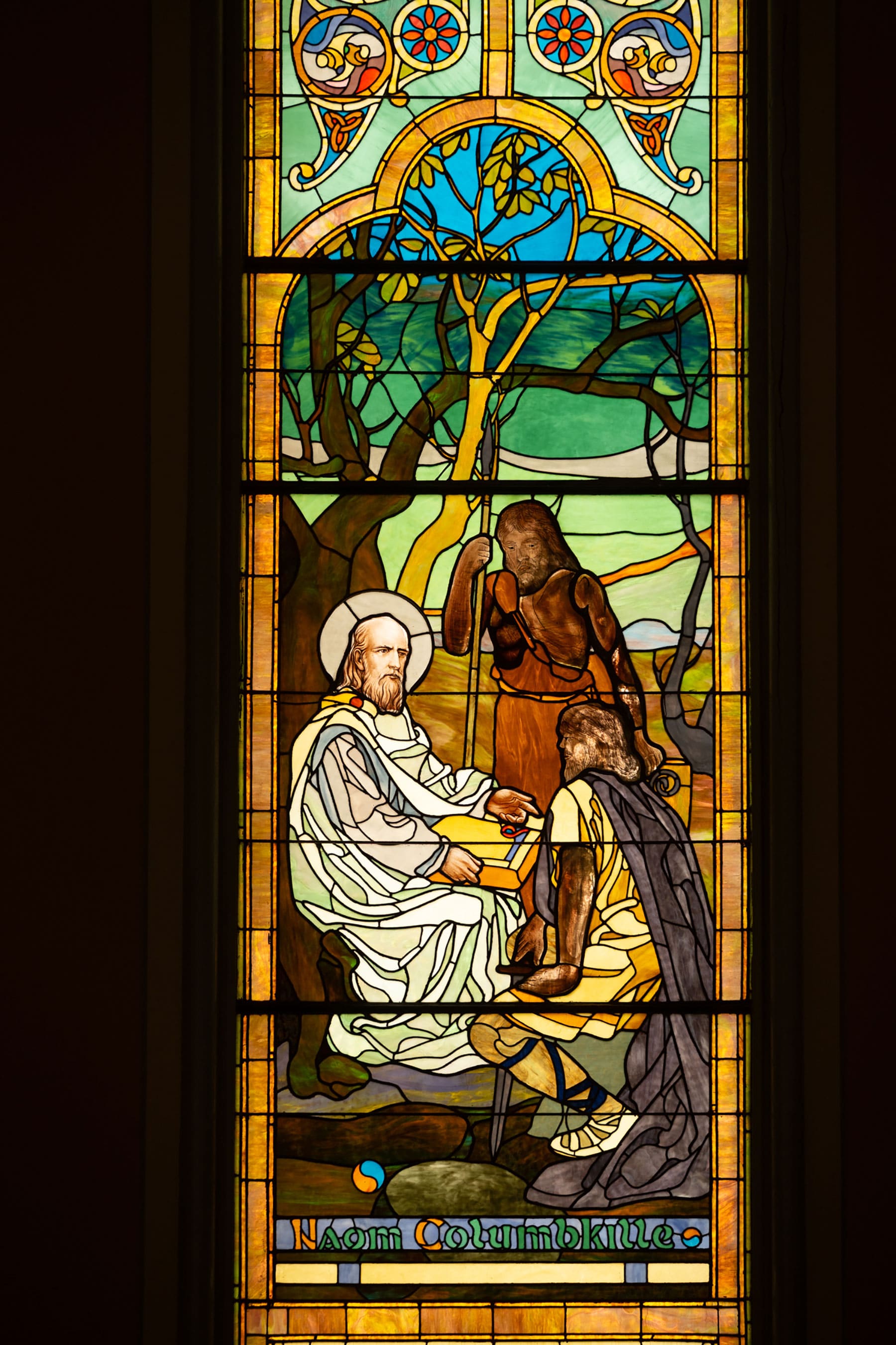 A stained-glass window panel depicting Saint Columba