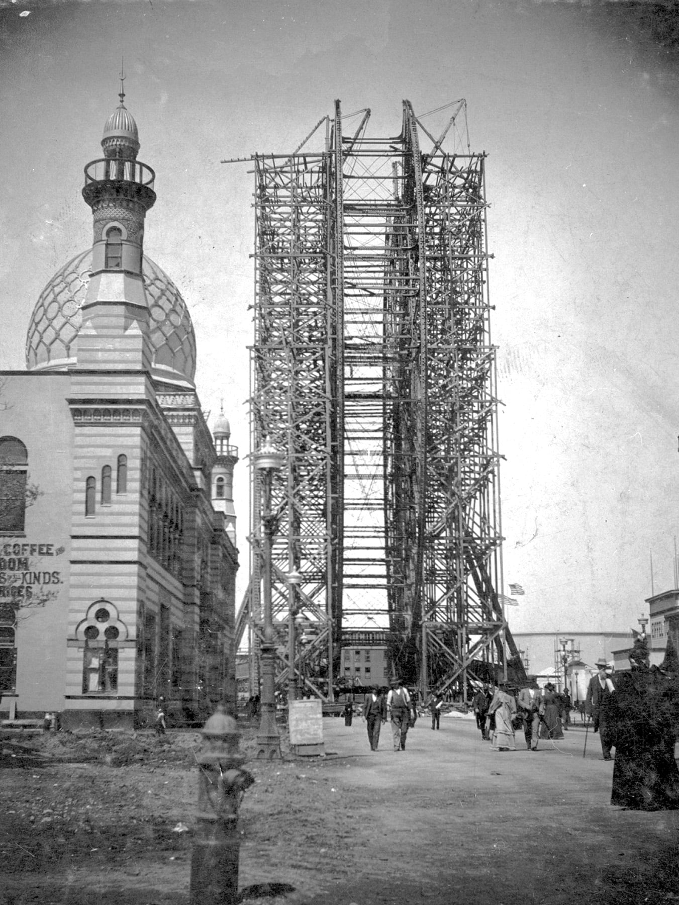 Construction on the Ferris wheel continued past the fair’s official opening.