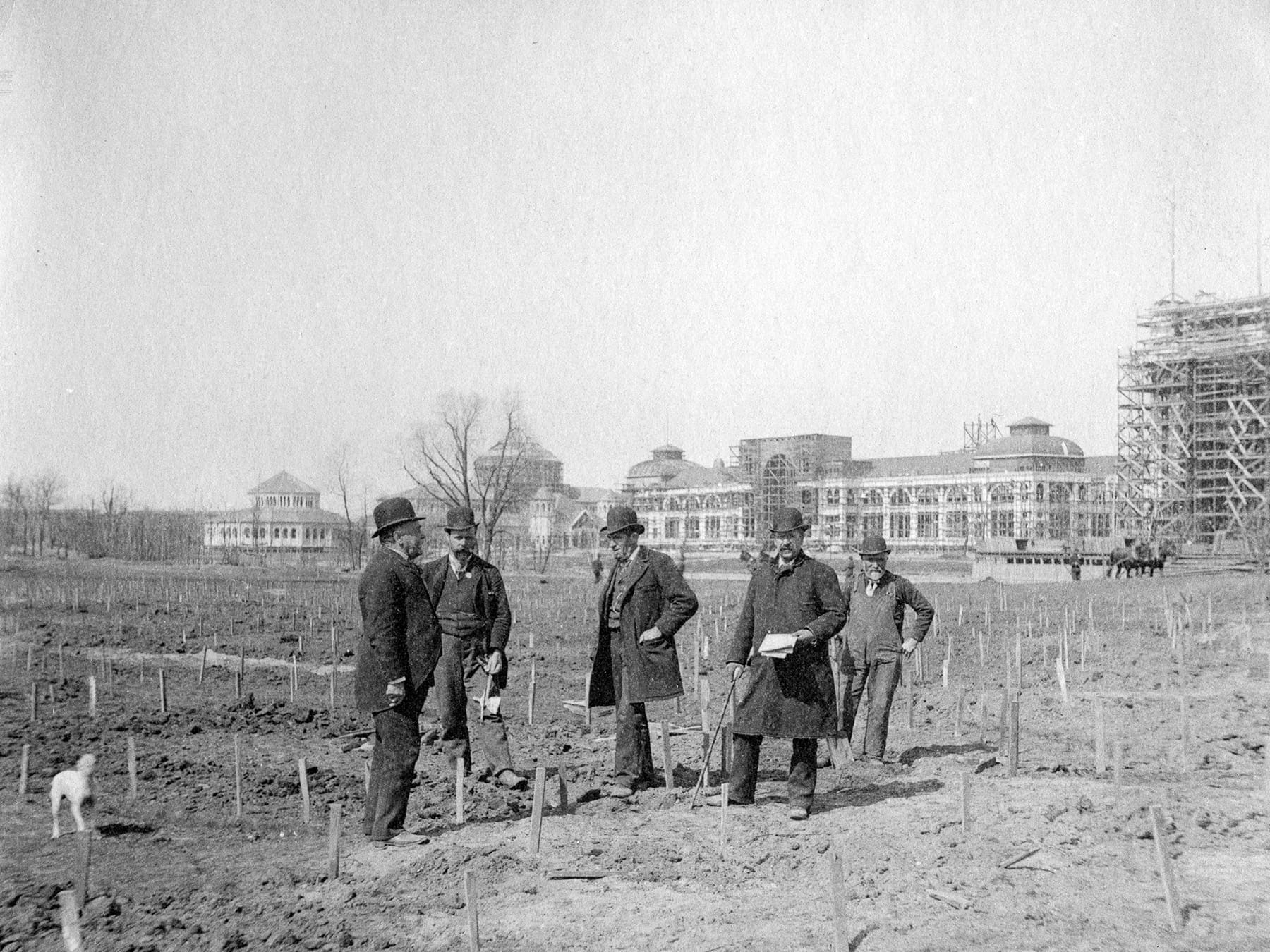 People standing in a field during construction of the World’s Columbian Exposition.