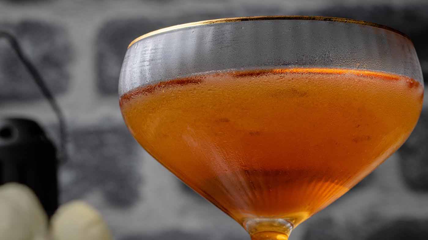 A Bijou cocktail in a coup glass