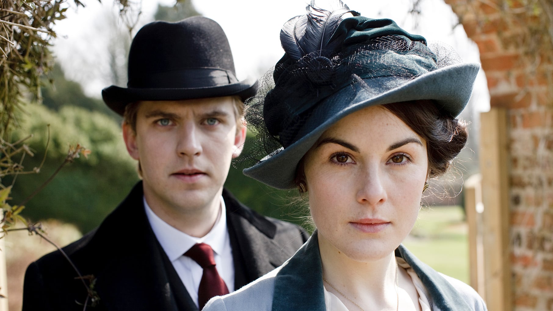 Matthew stands behind Mary in Downton Abbey