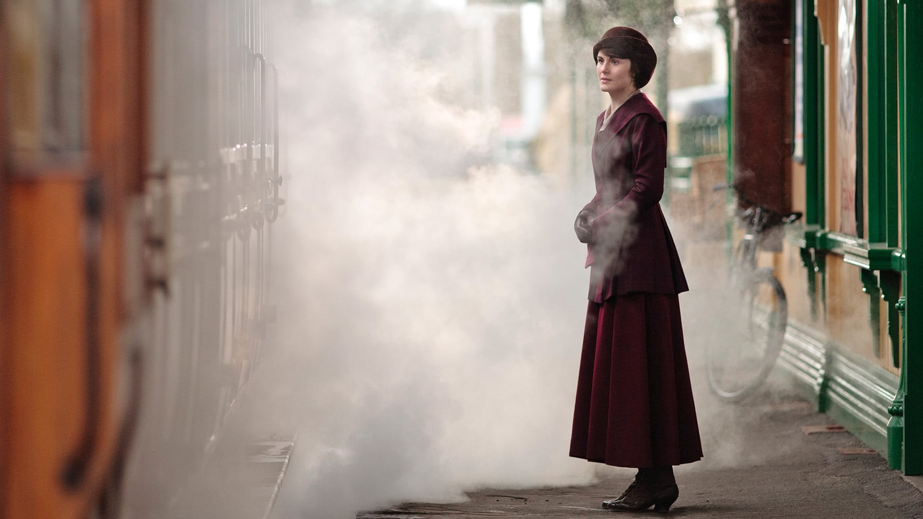 Mary stands amidst the smoke at the train station