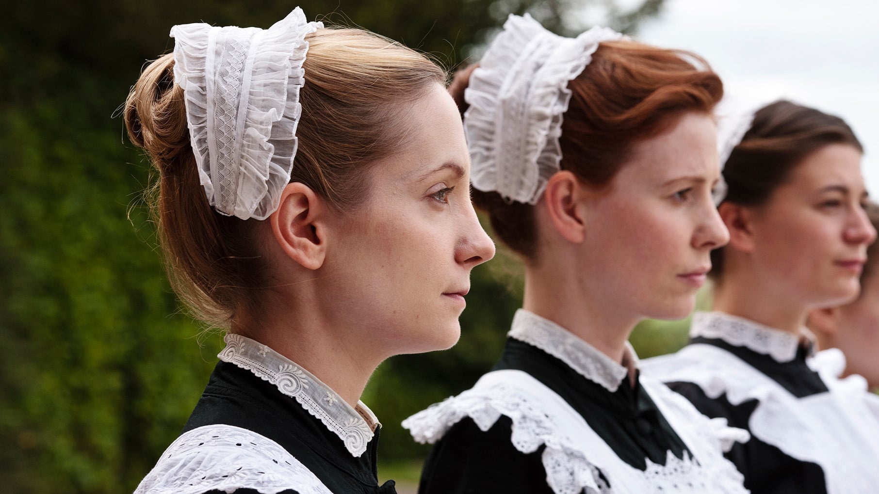 The maids stand at attention outside