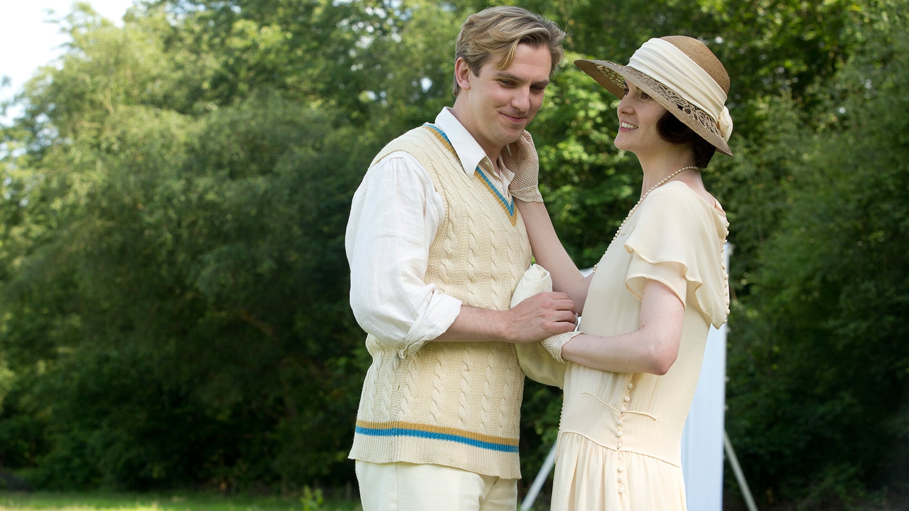 Matthew and Mary show affection in their cricket garb outside