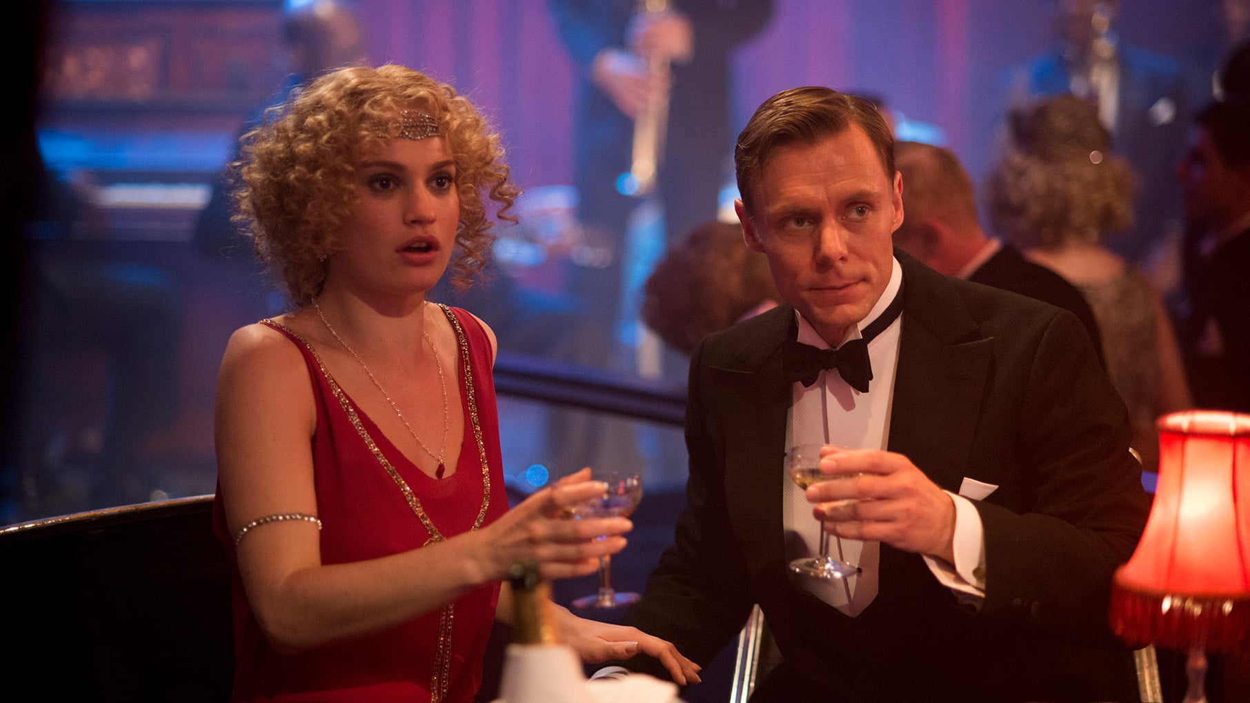 Rose looks shocked in evening wear at a table with a man in a tuxedo in a club