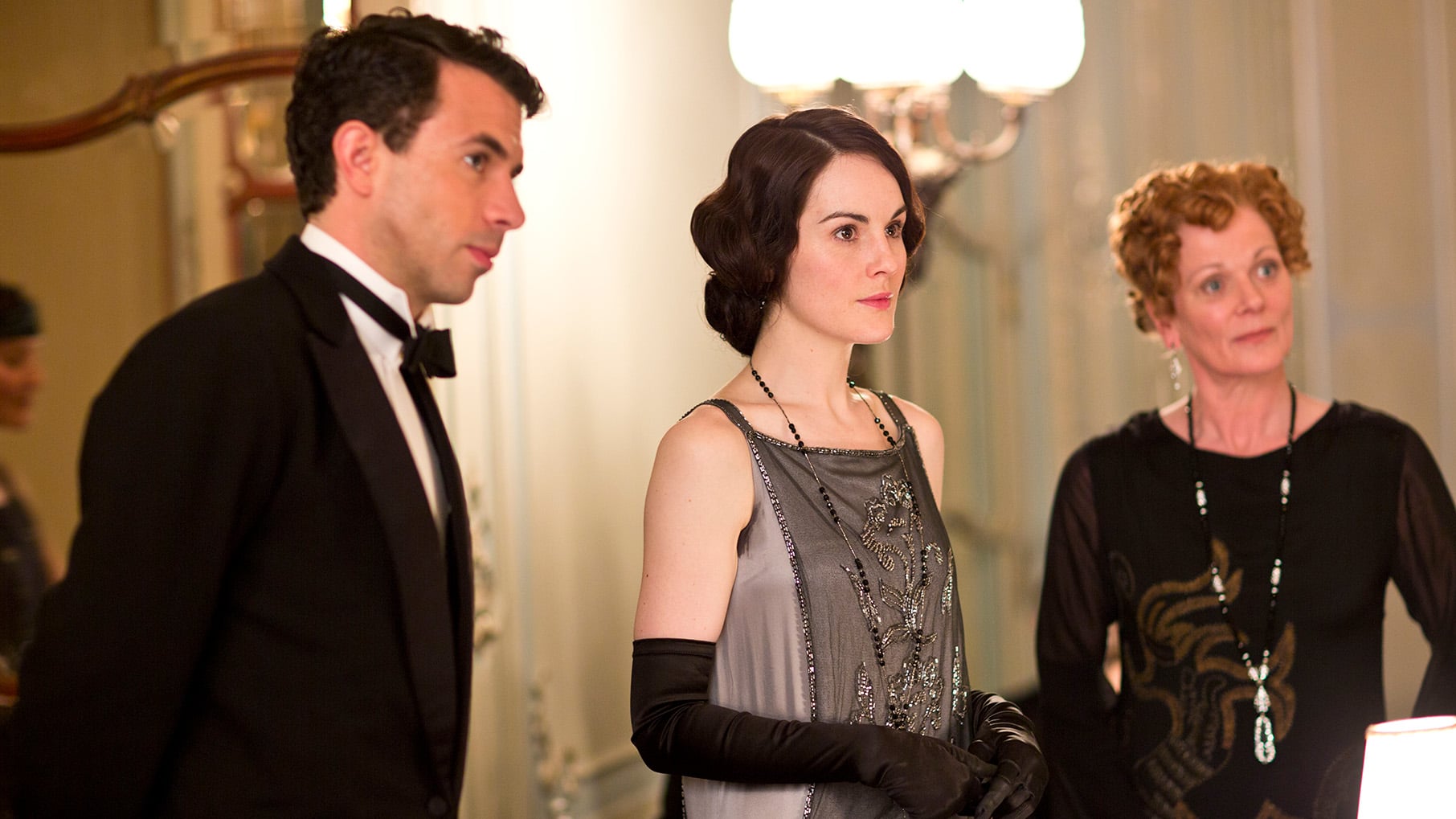 Gilingham, Mary, and Rosamond stand in fine evening wear