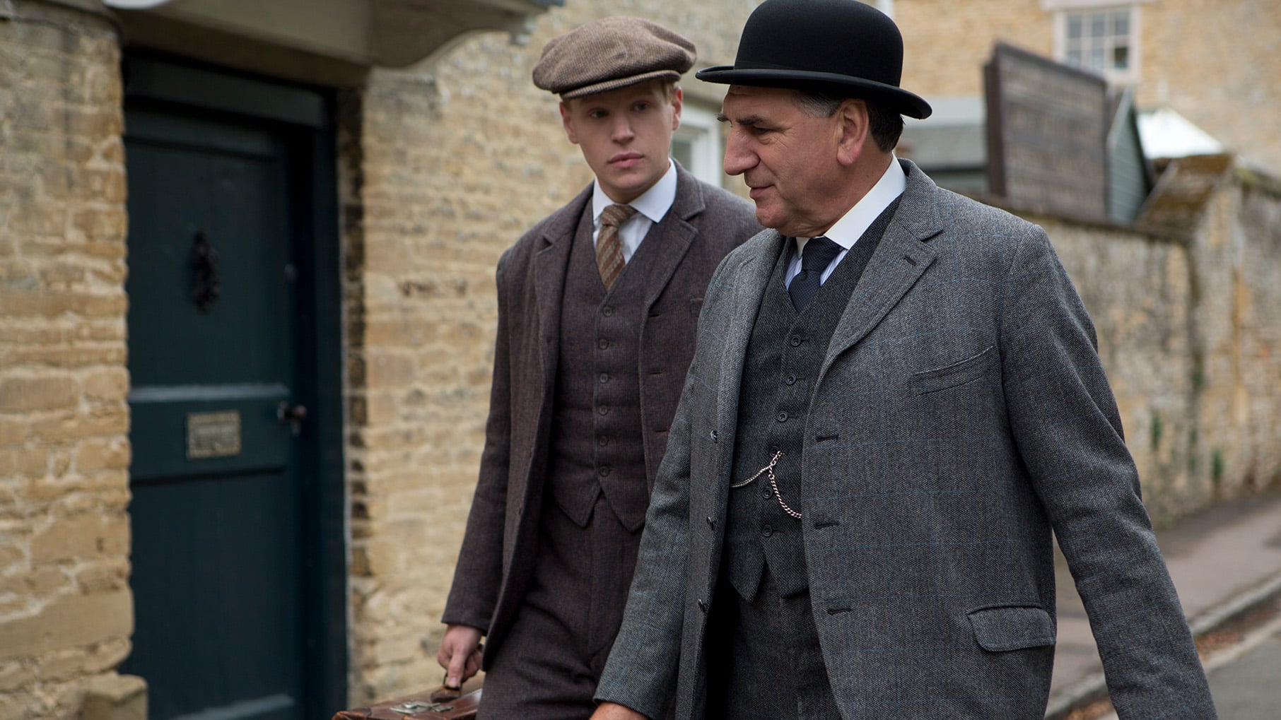 Carson walks down a street with Alfred