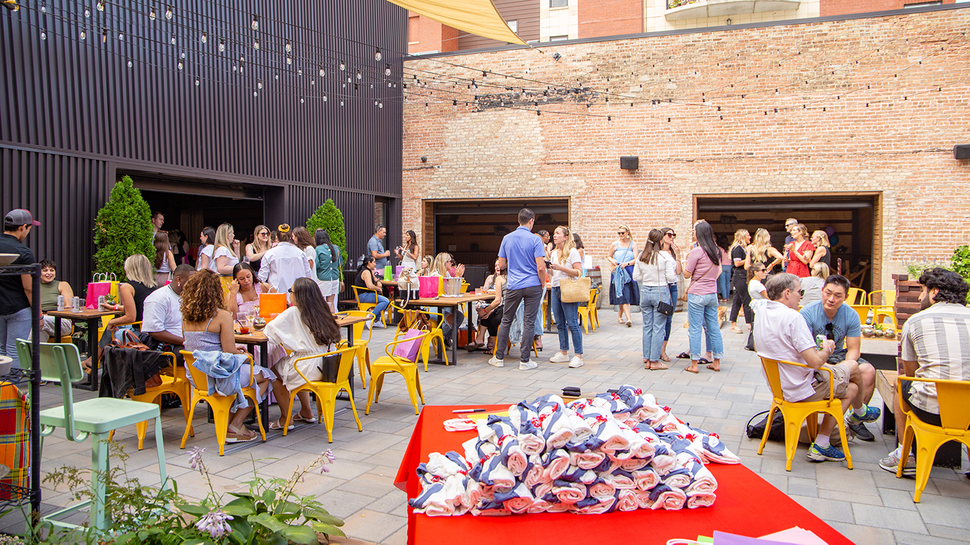 People sit and stand and socialize in a courtyard