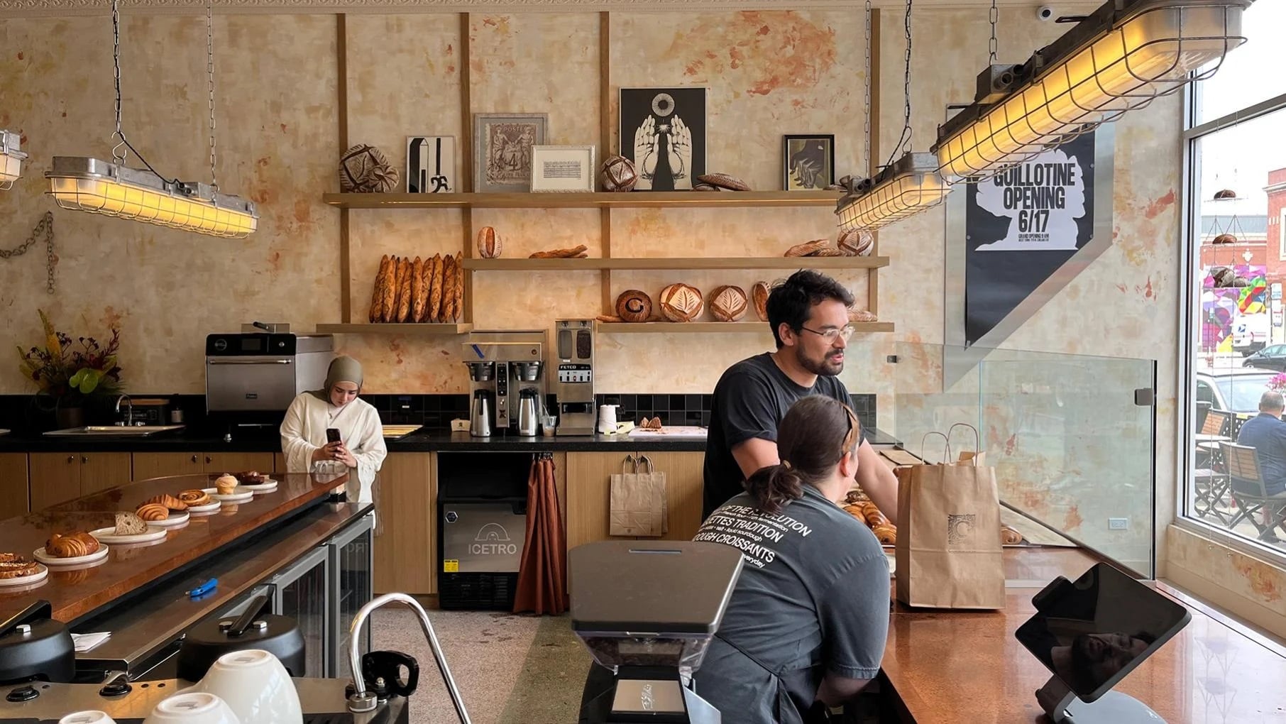 People behind the counter of a bakery