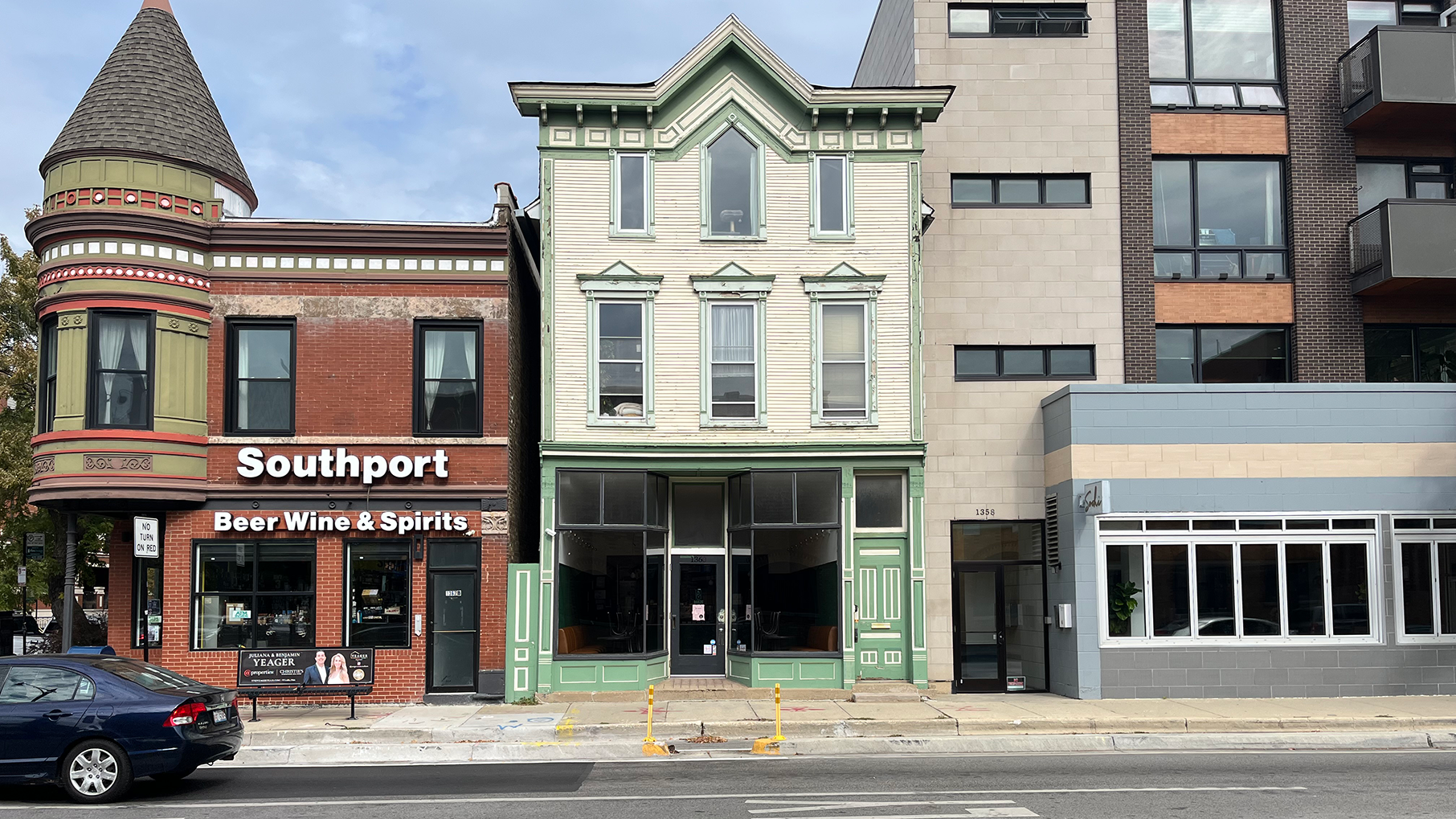 Three buildings in a row on a street