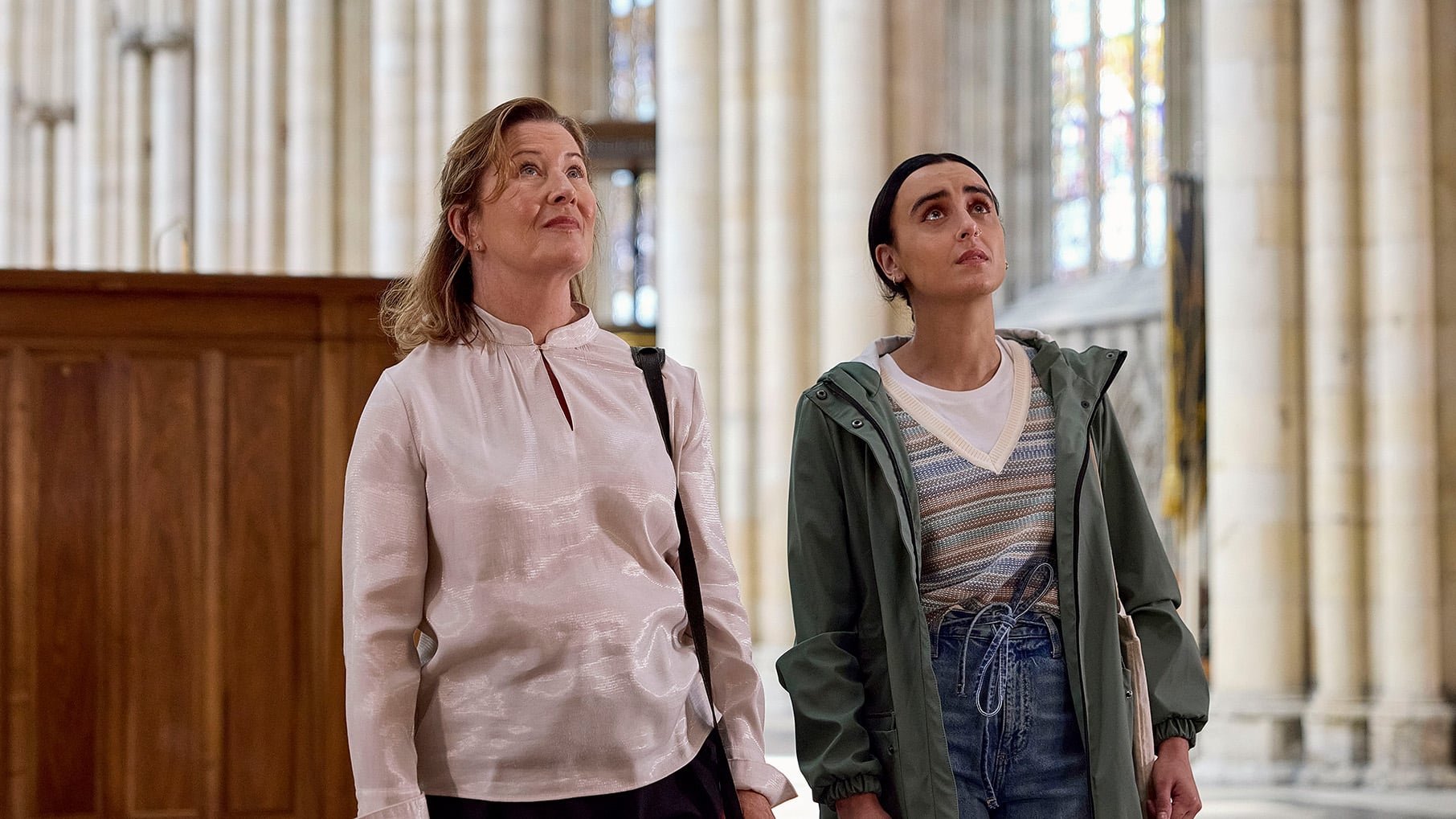 Bernie and Vanessa stand in a church looking up