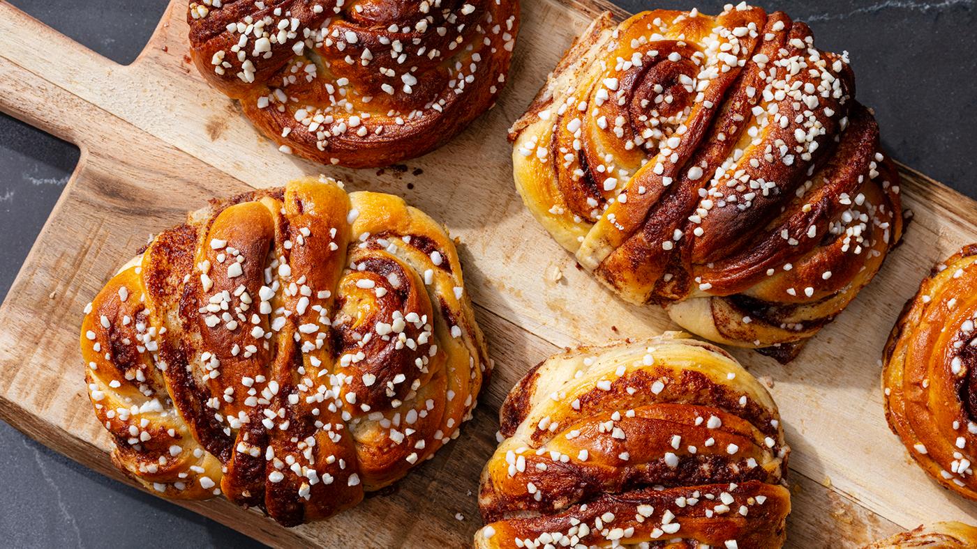 Kanelbullar on a wooden serving slab