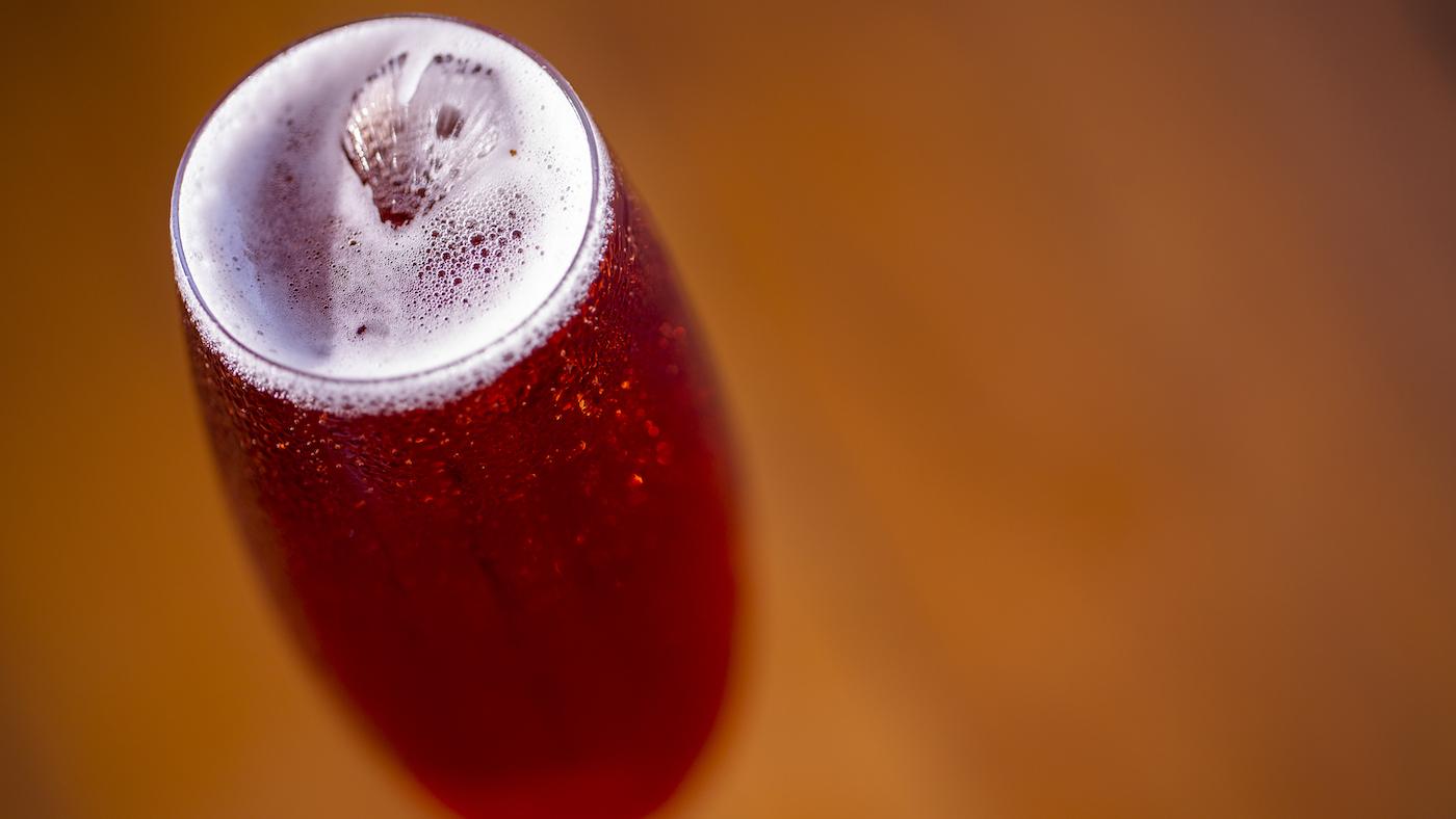 An overhead shot of a Kir Royale cocktail in a flute glass