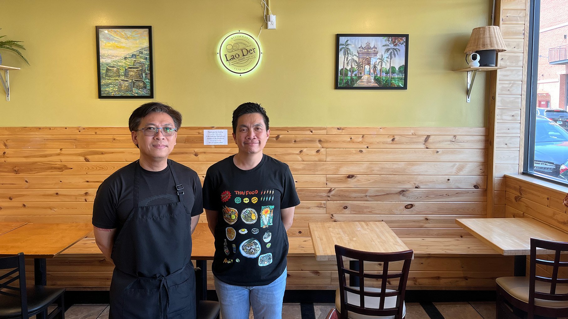 Two men smile in a restaurant