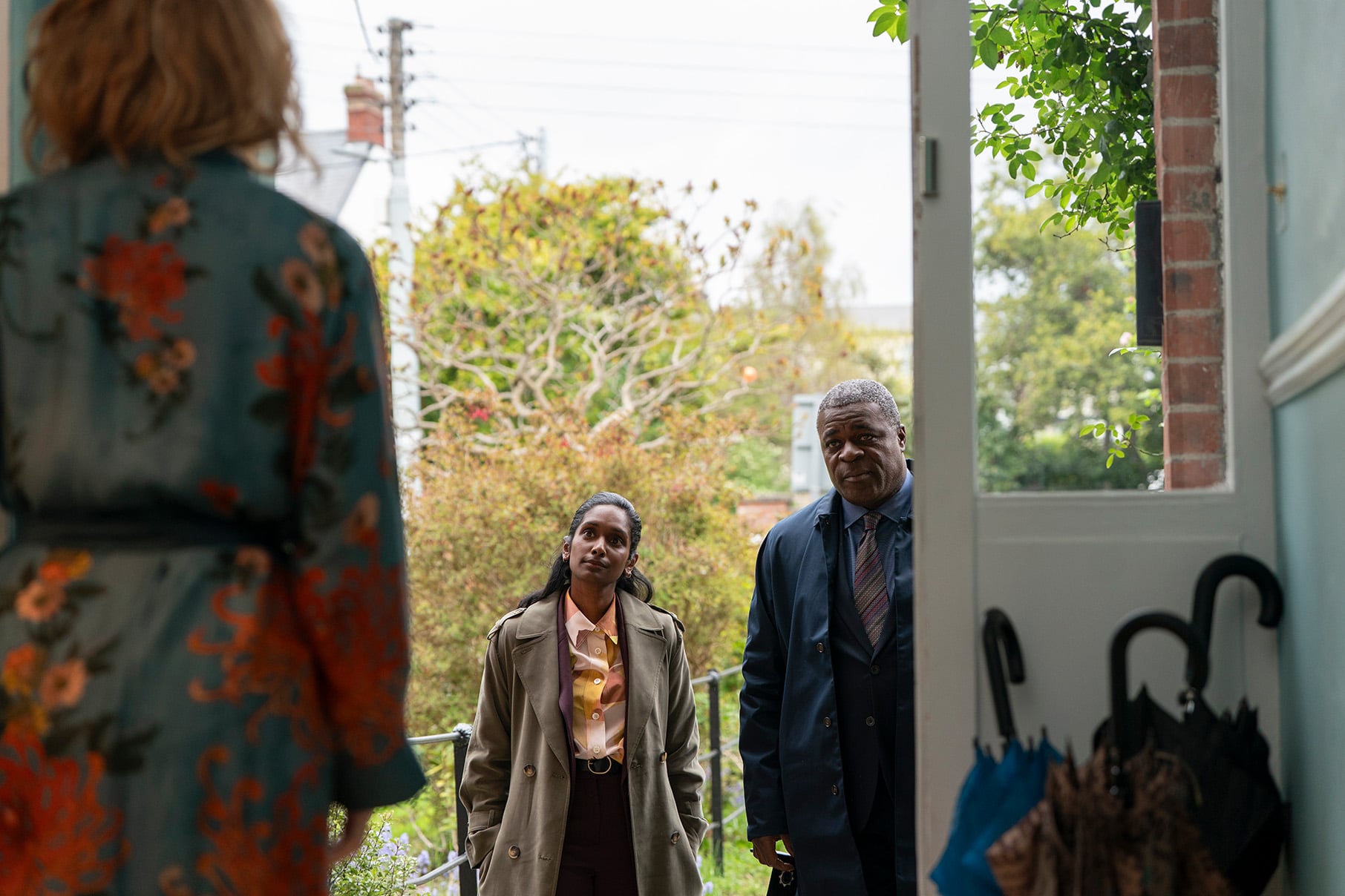 Detectives Wardlaw and Blakeney stand outside Susan's door
