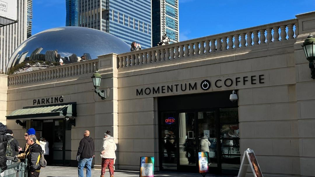 The Millennium Park location of Momentum Coffee, below the Bean and a blue sky