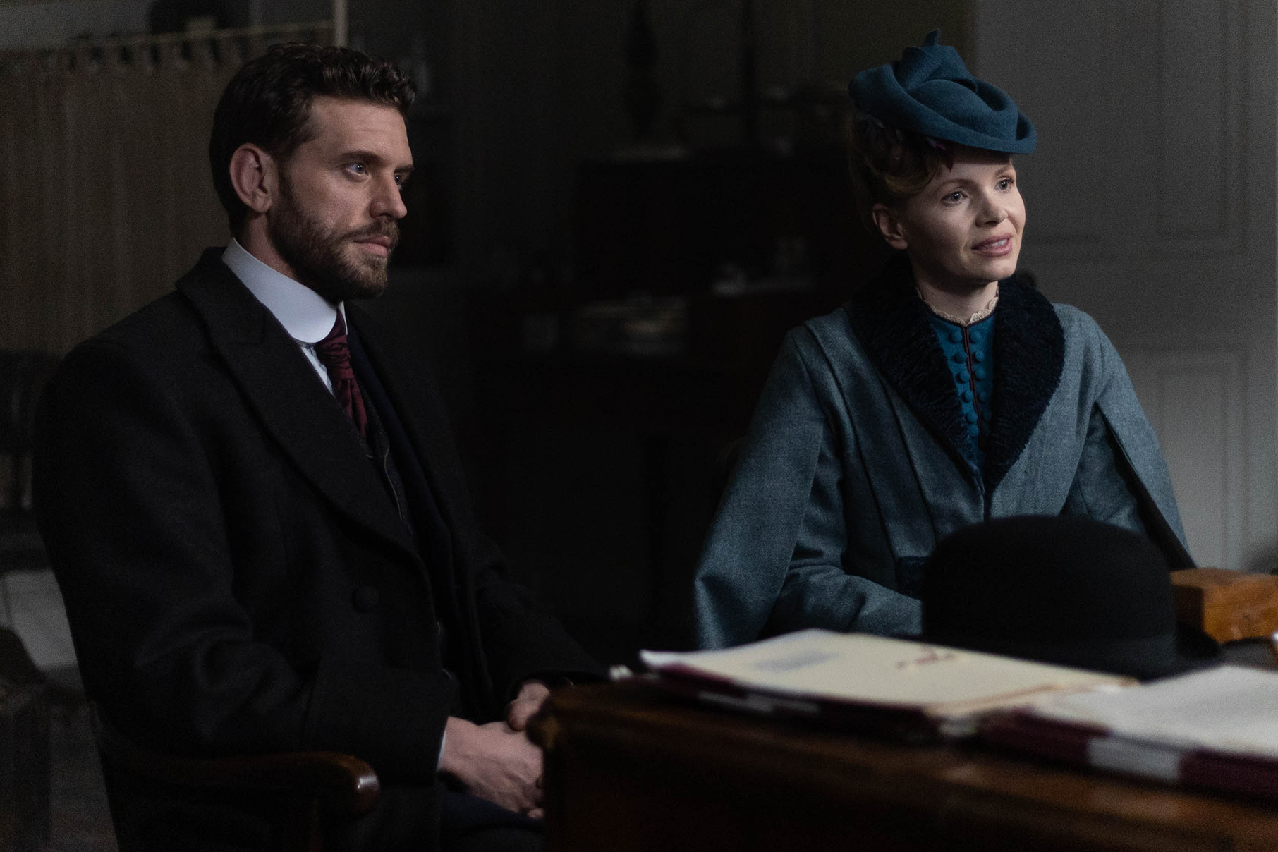 Miss Scarlet and Alexander Blake sit next to each other