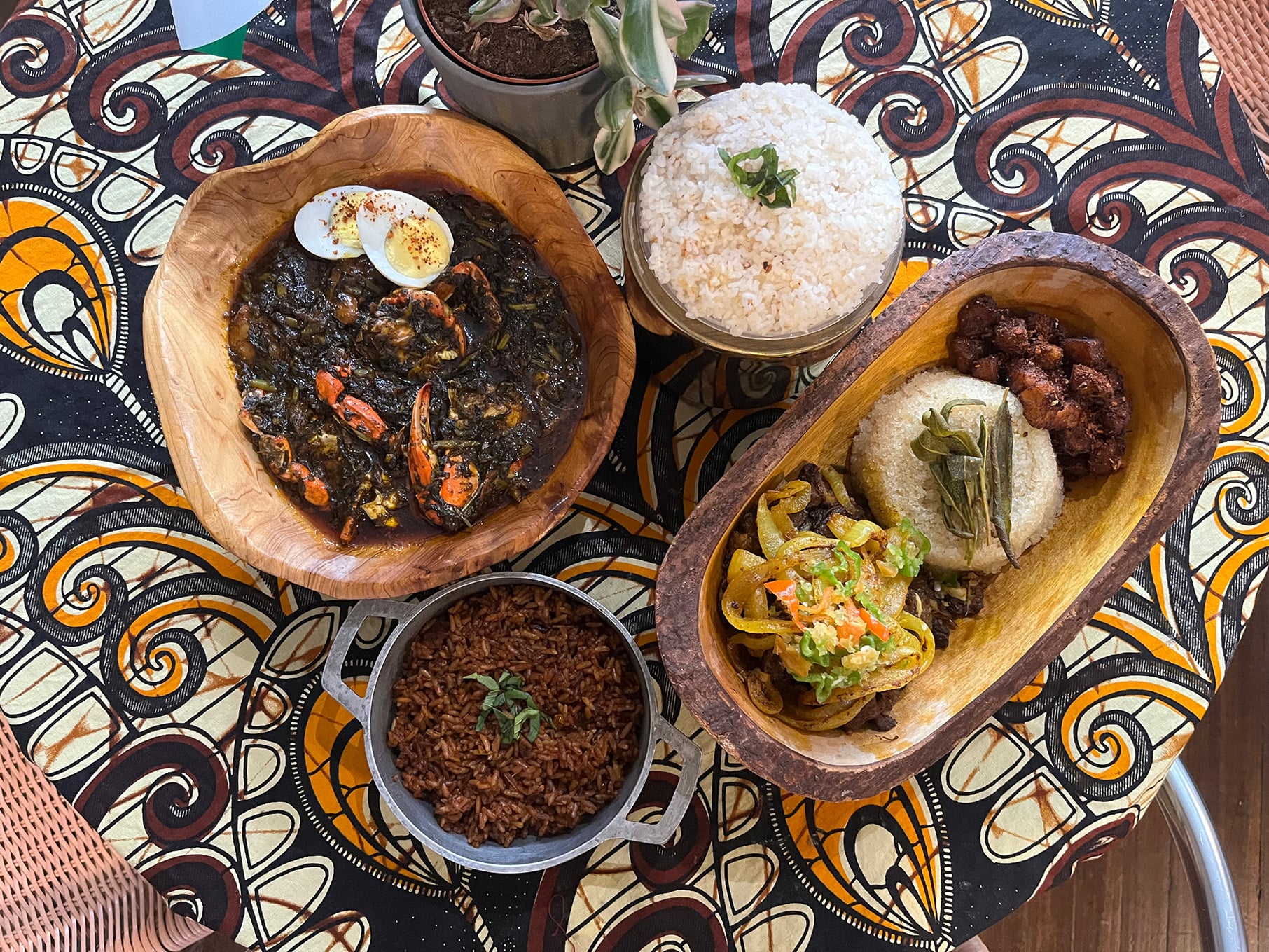 A spread of food on a table with an African print tablecloth