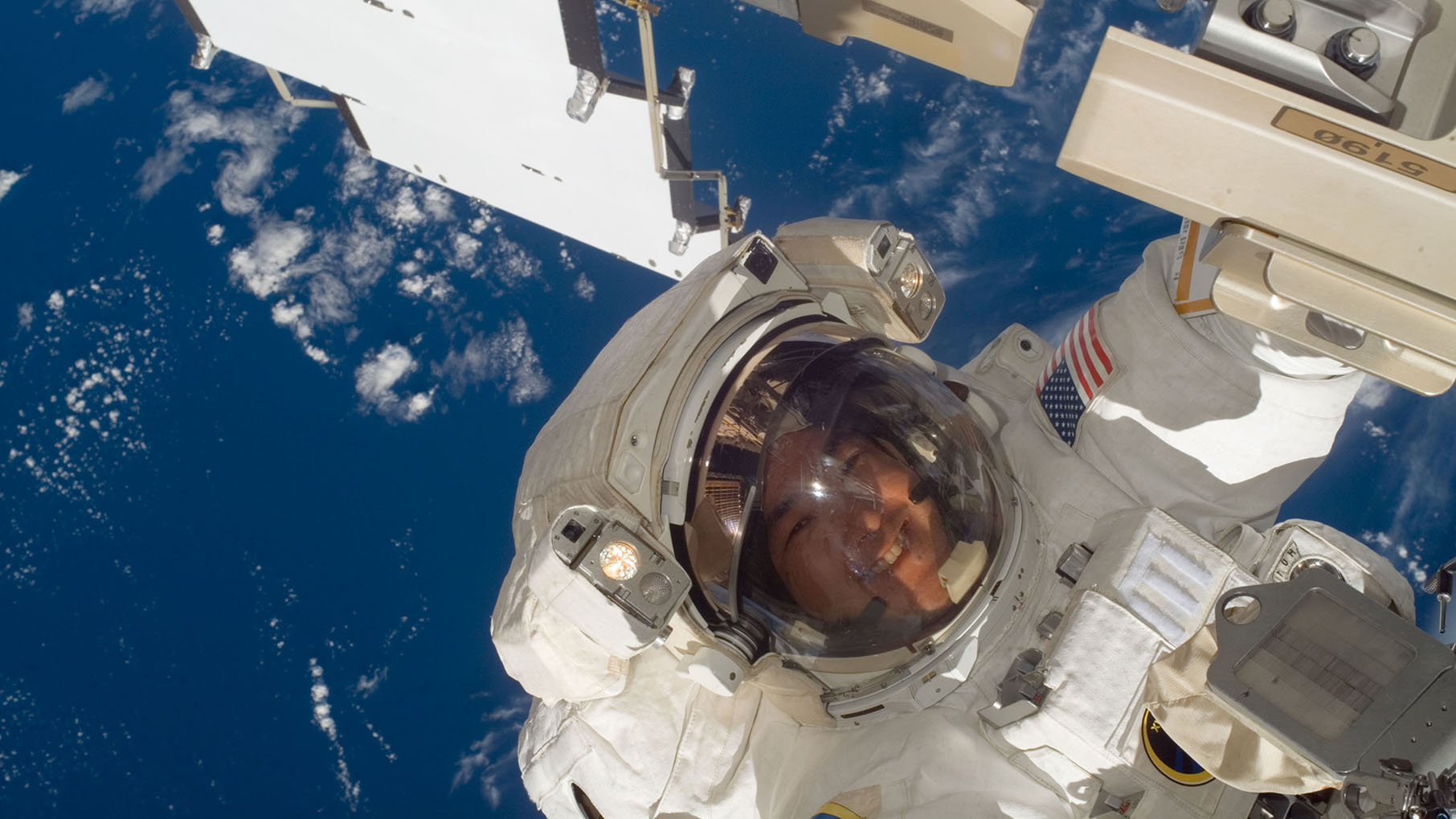 Daniel Tani on a spacewalk with Earth visible behind him