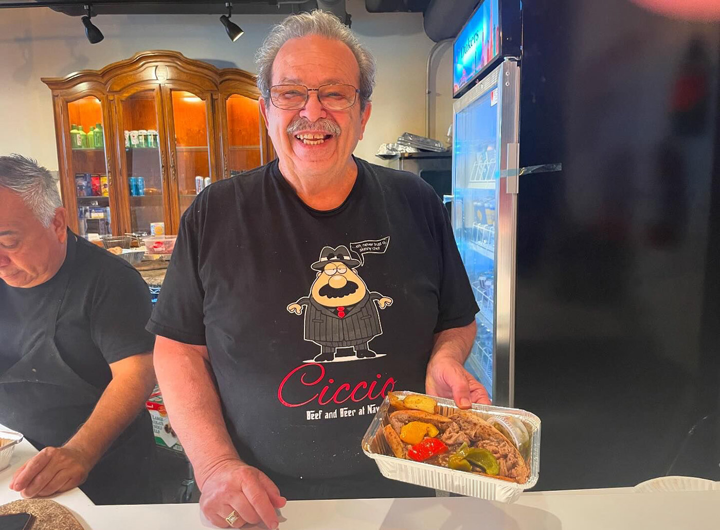 Mario Ferraro serves an Italian beef sandwich at Ciccio