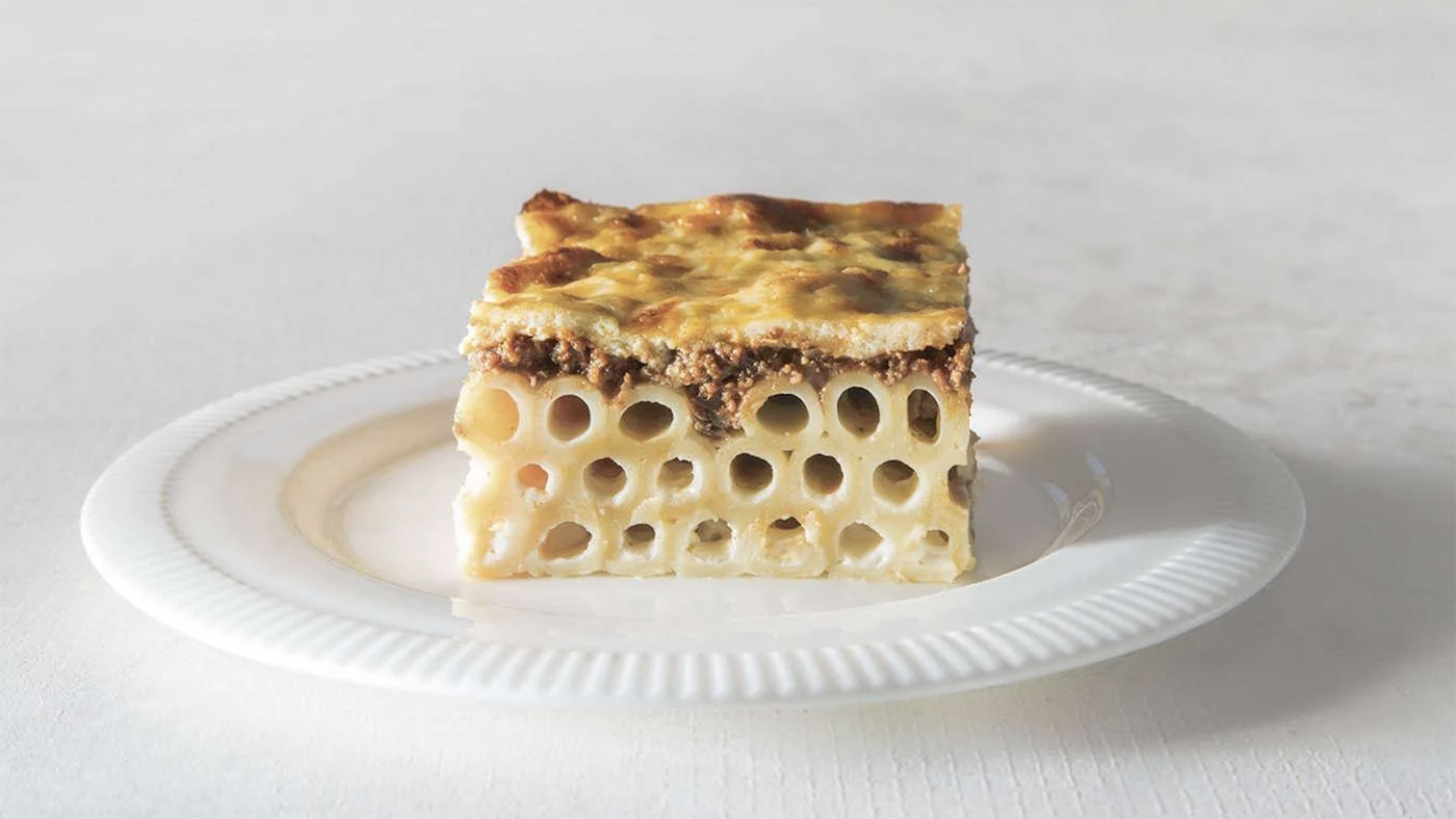 A slice of pastitsio on a white plate