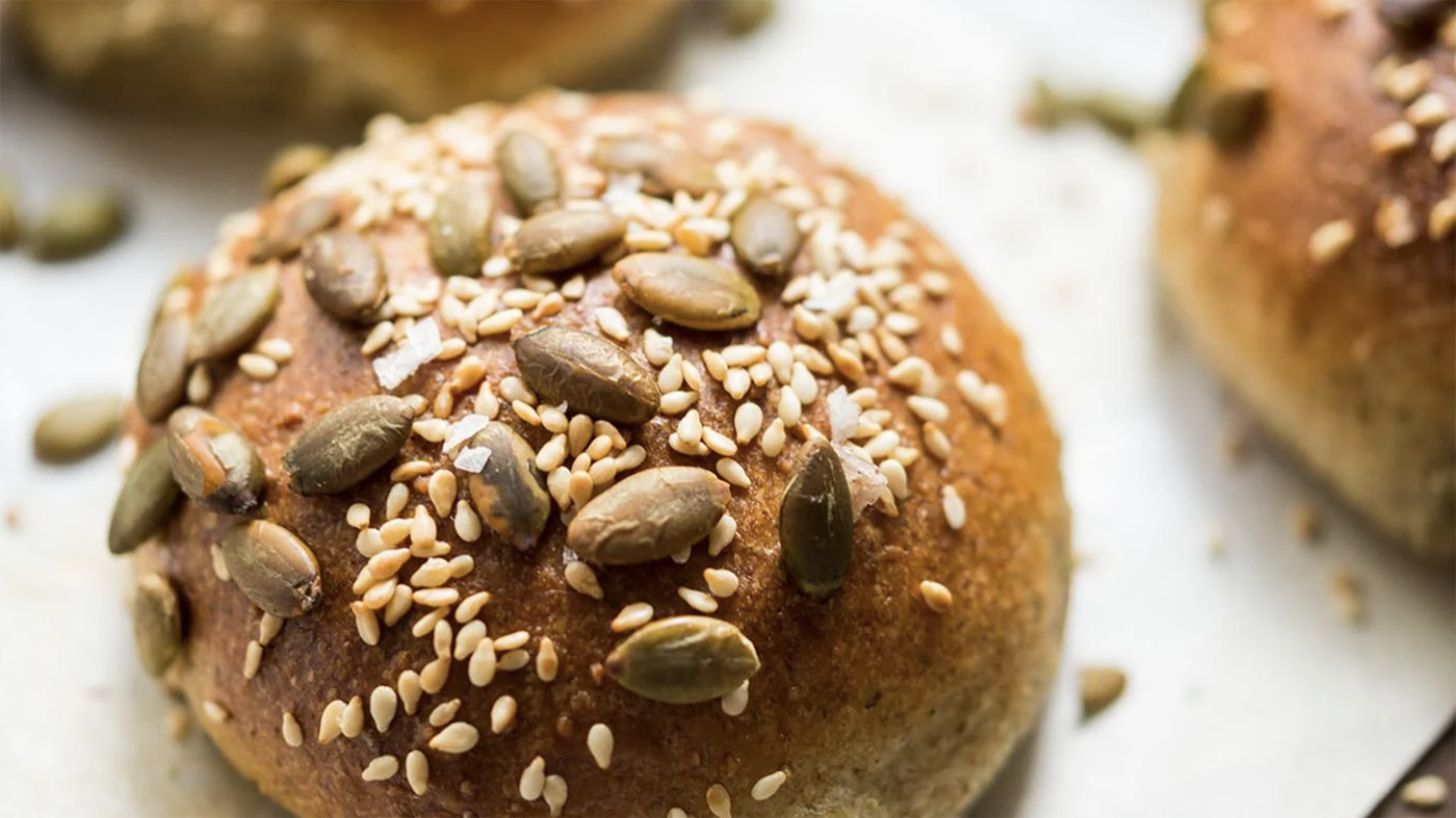 A pumpkin seed roll on a sheet pan